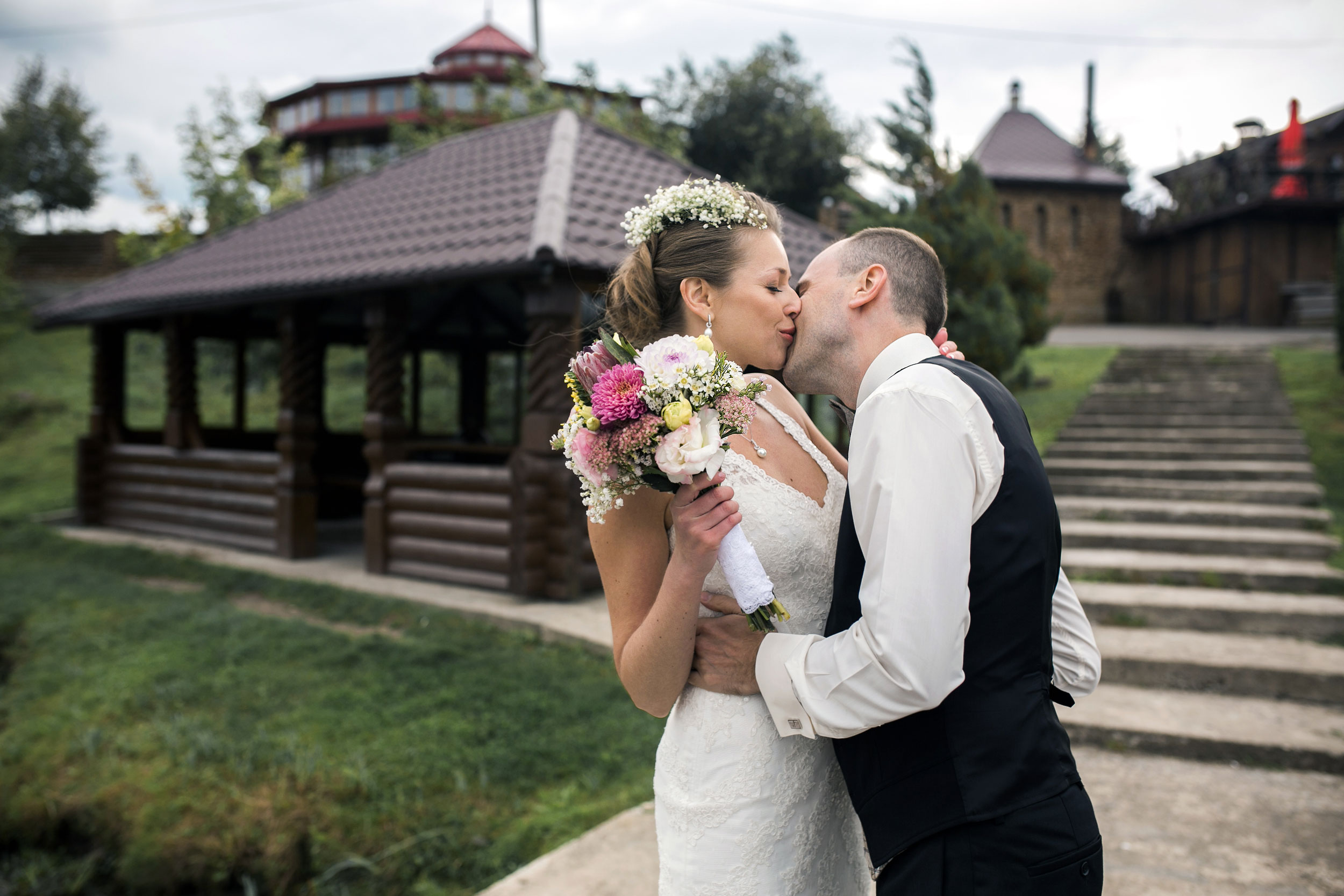 bride and groom close-up sharing a kiss